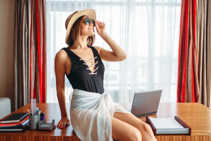 Woman sitting on table, thinking about adventure Woman sitting on table, thinking about adventure