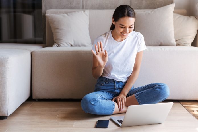 Cheerful young asian woman having a videocall Cheerful young asian woman having a videocall