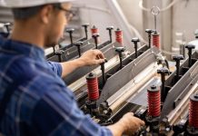 Industrial equipment being operated by young professional technician or engineer