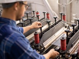 Industrial equipment being operated by young professional technician or engineer
