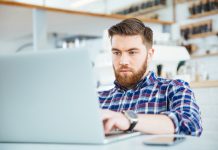 Man using laptop computer in cafe