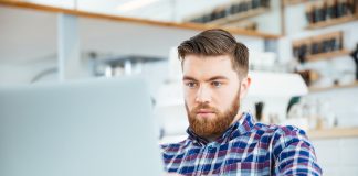 Man using laptop computer in cafe