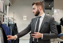 Businessman choosing clothes in store