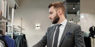 Businessman choosing clothes in store