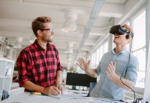 Young men testing virtual reality technology