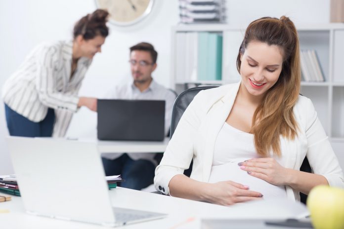Pregnant woman at work Pregnant woman at work
